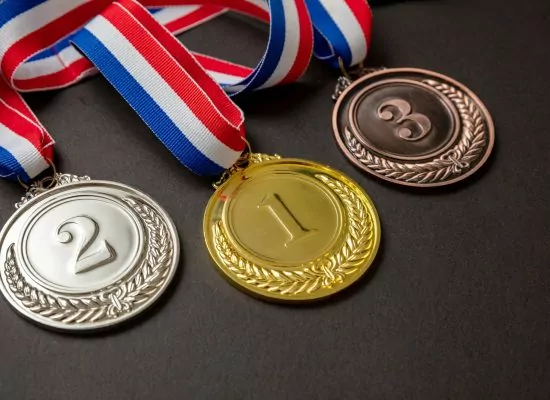 Gold, silver and bronze medals set on black background. Sports athletes winners prize